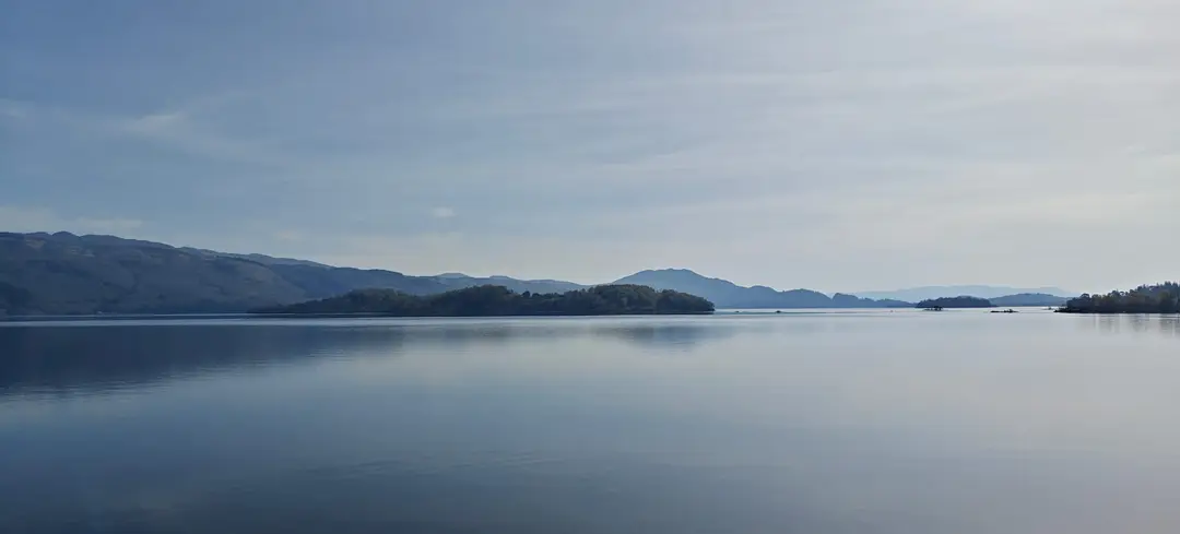 Loch Lomond, mirror-still under morning haze