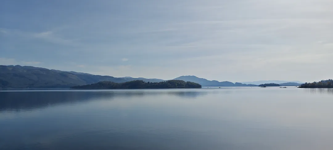 Loch Lomond, mirror-still under morning haze