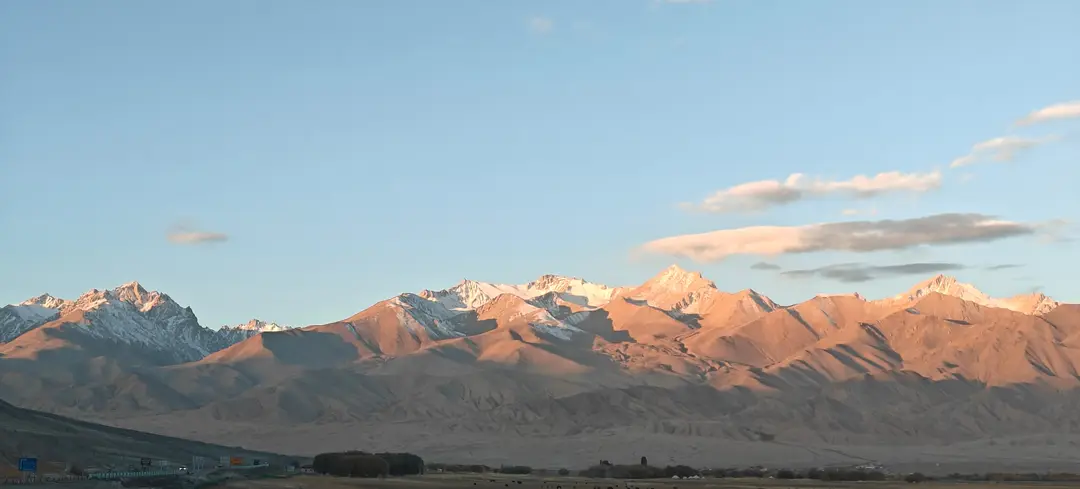 Morning light warms the snow peaks and ridges above the Taheman Valley